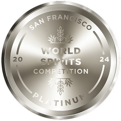 A circular platinum medal from the 2024 San Francisco World Spirits Competition. The medal features engravings with the event name "San Francisco World Spirits Competition 2024," wheat icons, and the word "PLATINUM" at the bottom.