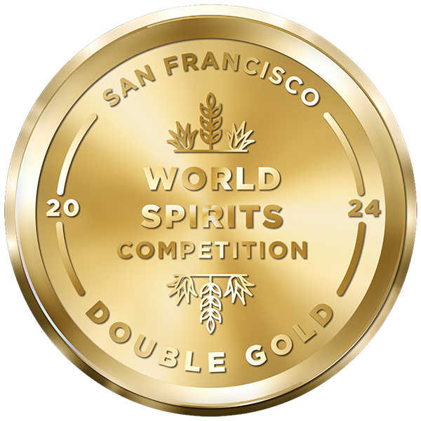 A gold medal with the inscription "San Francisco World Spirits Competition 2024 Double Gold." The medal features decorative wheat and barley designs at the top and bottom.