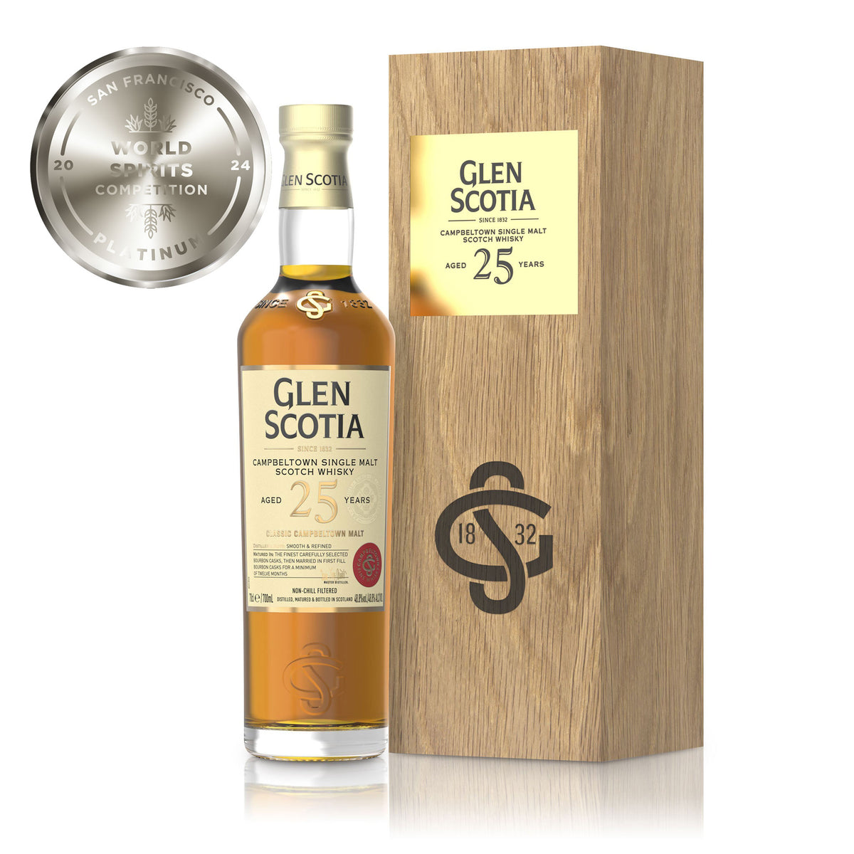 Photo of a Glen Scotia 25 Year Old Single Malt Scotch Whisky bottle positioned next to a wooden box. The bottle&#39;s label includes information about the whisky&#39;s age and origin. To the left of the image, a silver &quot;World Spirits Competition 2024 Platinum&quot; medal is prominently shown, making it a perfect option for whisky gifts.