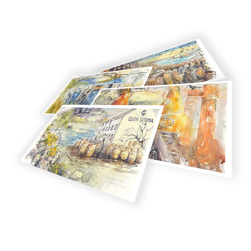 A display of the Spirit Safe Postcard Collection by Glen Scotia, featuring four watercolor postcards arranged in a scattered layout against a black background. Each postcard showcases different scenic artwork from the Kintyre Peninsula, highlighting rustic buildings, wooden barrels, and landscapes. One of the postcards includes the text "Glen Scotia.